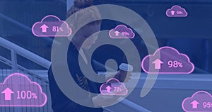 Animation of cloud icons with growing number over caucasian businesswoman using smartphone