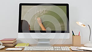 Animation of a computer monitor showing Caucasian female teacher on the screen