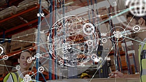 Animation of connected icons, globe, low angle view of caucasian coworkers discussing in warehouse