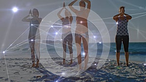 Animation of connections over diverse women practicing yoga on beach at sunset