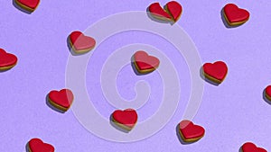 Animation. Cookies in shape of heart on dessert. Food pattern with sweet bakery over violet background flat lay top-down