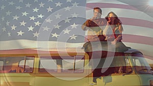 Animation of flag of america, diverse couple with blanket and drink sitting on van against sky