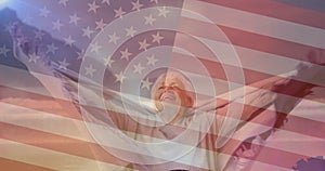 Animation of flag of united states of america over senior woman having fun