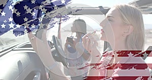 Animation of flag of usa over happy diverse women in car by beach in summer