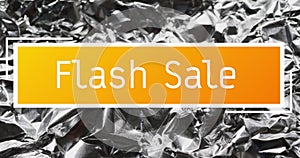 Animation of flash sale text over close up of crumpled paper