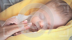 Animation of frame over caucasian mother kissing hand of her baby