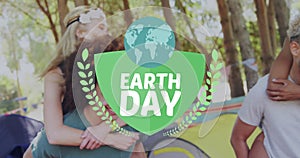 Animation of globe with earth day text over diverse friends in forest