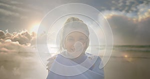 Animation of glowing light over portrait of happy senior woman