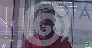 Animation of graphs and trading boards over smiling african american woman in office