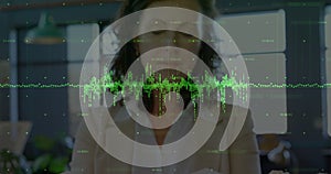Animation of green soundwaves and numbers over caucasian businesswoman reviewing architectural model