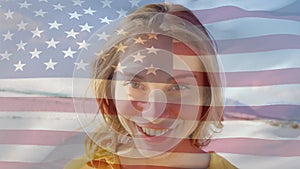 Animation of happy caucasian woman by sea over flag of usa