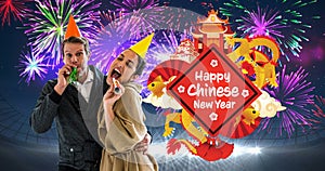 Animation of happy chinese new year text, with dragon and temples, celebrating couple and fireworks