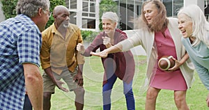 Animation of happy diverse female and male senior friends playing american football in garden