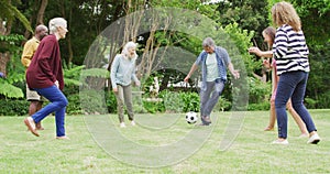 Animation of happy diverse female and male senior friends playing soccer in garden