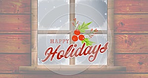 Animation of happy holidays christmas text with holy over winter snowy window