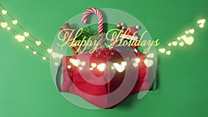 Animation of happy holidays christmas text over lights and face mask on green background