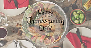 Animation of happy thanksgiving day text and dinner on table background