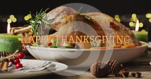 Animation of happy thanksgiving text and dinner on table background