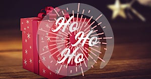 Animation of hohoho text at christmas over present