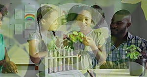 Animation of leaves over happy diverse male teacher and schoolgirls studying plants in biology class