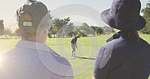 Animation of light trails over senior caucasian couple on golf course