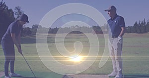 Animation of light trails over senior caucasian couple playing golf on golf course