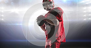 Animation of male american football player holding ball at floodlit stadium