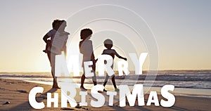 Animation of merry christmas text over happy african american family walking on sunny beach