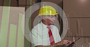 Animation of multiple graphs over caucasian manager wearing helmet using digital tablet in warehouse