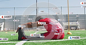 Animation of multiple notification bars over biracial soccer player doing stretching on ground