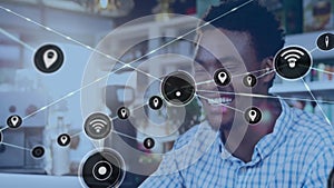 Animation of network of connections with wifi cons over african american man in cafe