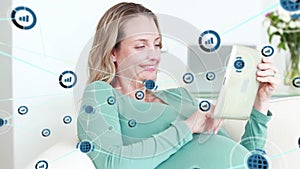 Animation of network of datacommunication icons over happy pregnant caucasian woman using tablet