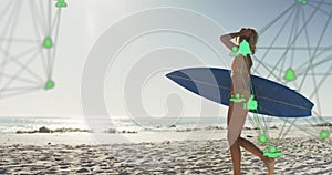 Animation of networks of connections with icons over woman with surfboard on beach