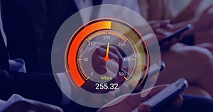 Animation of orange speedometer over hands of diverse businesspeople with electronic devices