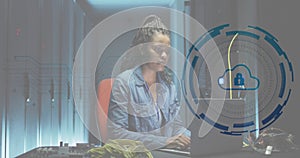Animation of padlock in circle over african american female engineer using laptop at data centre