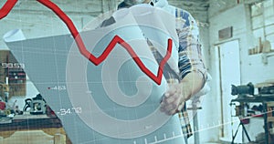 Animation of red graph processing over mature caucasian male carpenter with blueprints in workshop