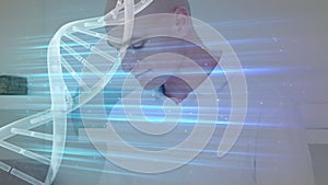 Animation of rotating dna helix with light beam over bald smiling businessman using digital pc
