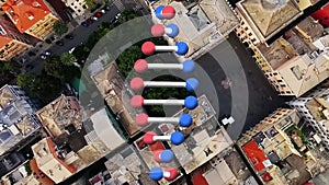 Animation of rotating dna strand moving over aerial view of modern cityscape