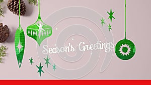 Animation of seasons greetings text over christmas pine cones