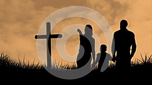 Animation of silhouette of Christian cross and family with one child over orange clouds