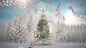 Animation of snow falling and candy canes over chritmas tree on winter landscape