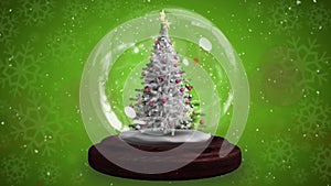 Animation of snow falling over chritmas tree on green background