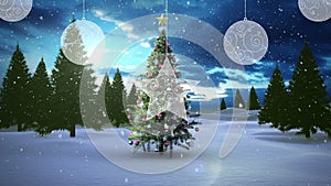 Animation of snow falling over chritmas tree on winter landscape