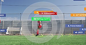Animation of social media icons against biracial male soccer player training on sports field
