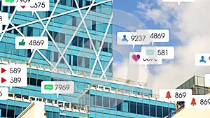 Animation of social networking notifications moving over modern city buildings