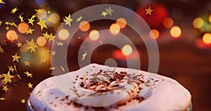 Animation of stars flying over christmas hot chocolate drink and candles