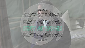Animation of stay at home be safe text over worried senior man at home