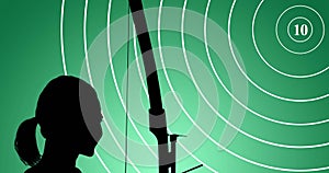 Animation of target and silhouette of female archer with bow on green background