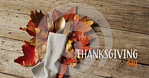 Animation of thanksgiving day text over place setting