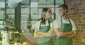 Animation of two smiling caucasian female and male workers with thumbs up in cafe